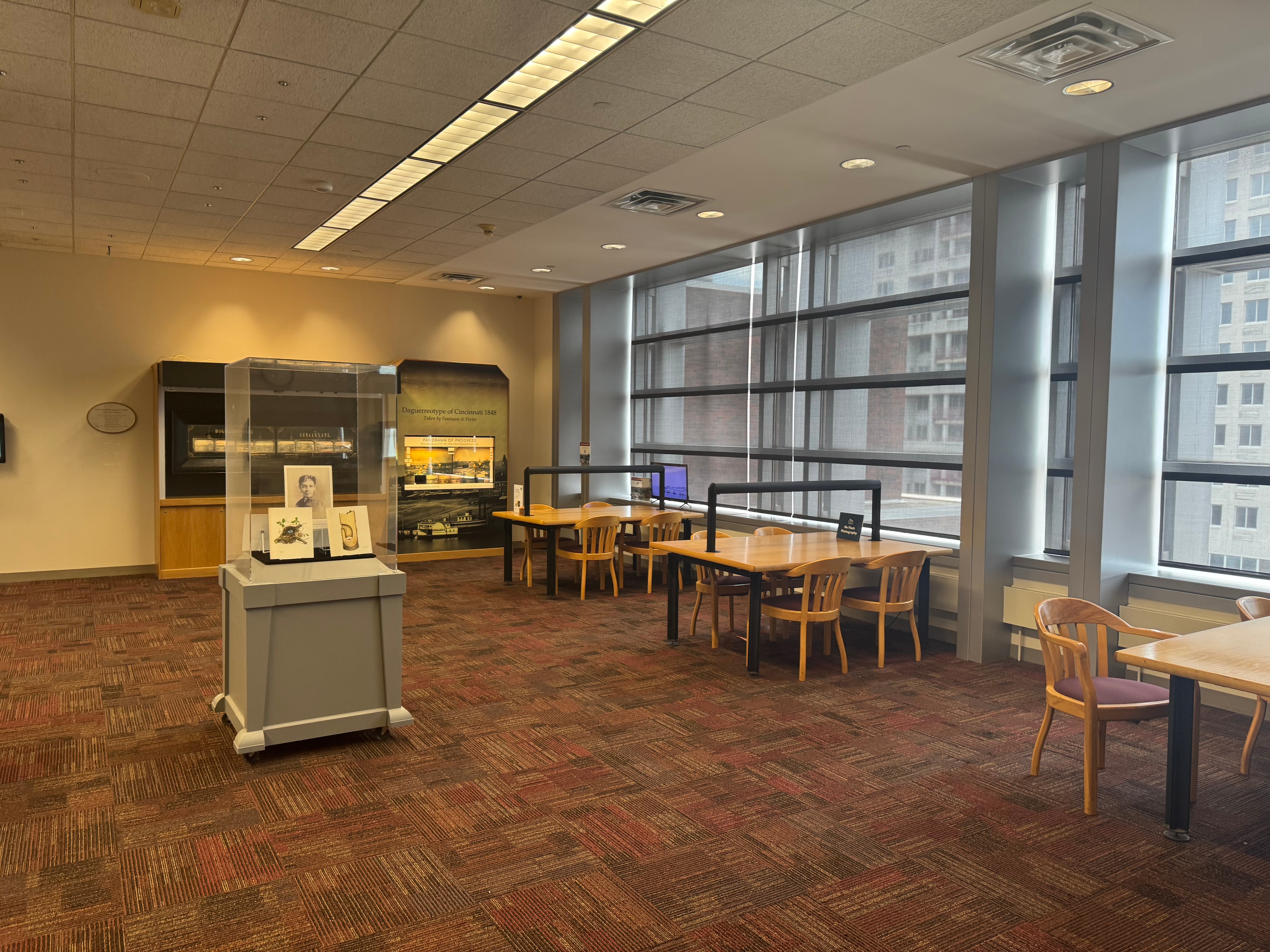 Cincinnati Room research desks with display cases and large windows