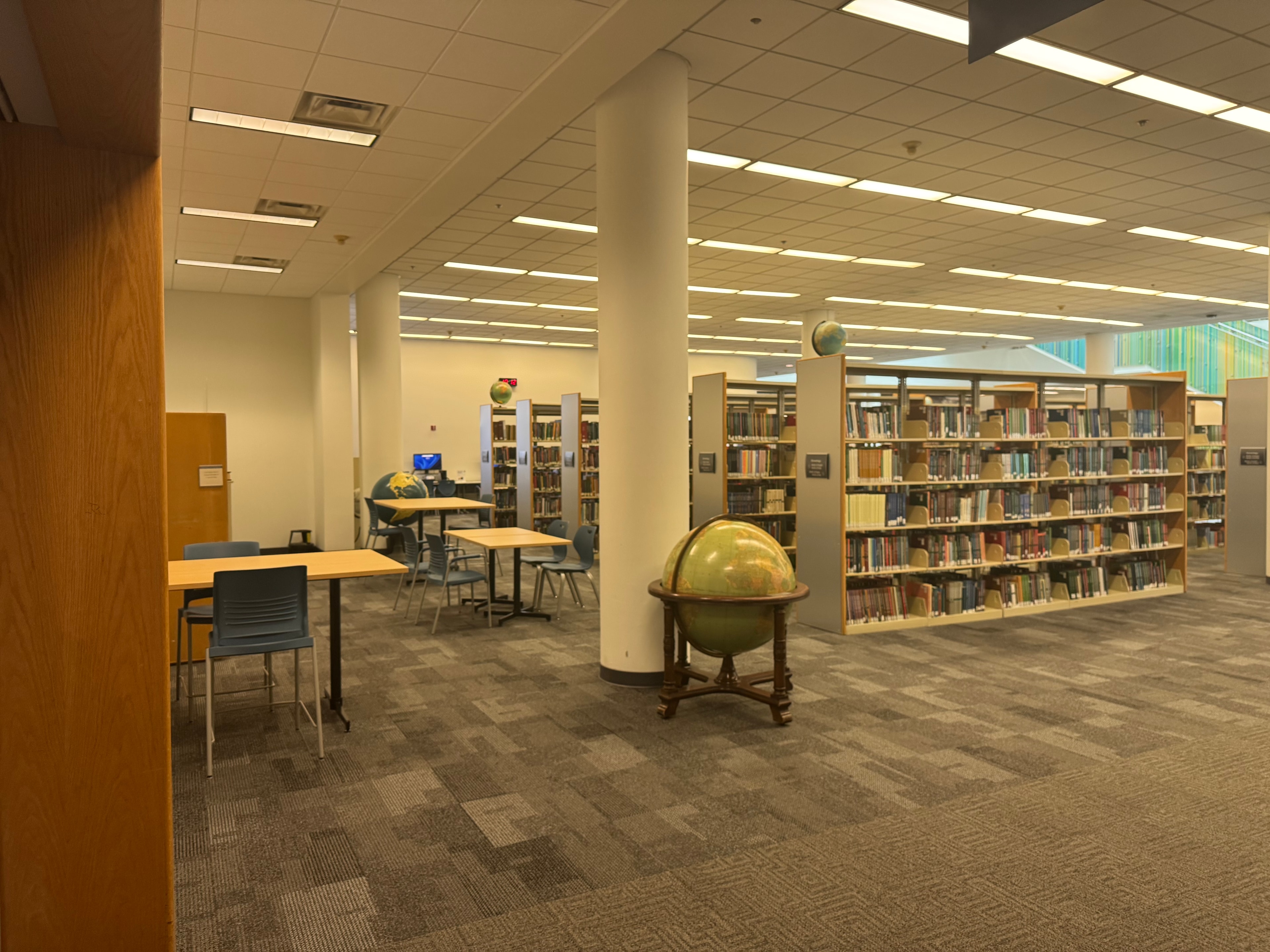 Cincinnati Public Library reference stacks and study area with globe and library shelving